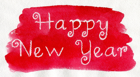 New Year. White lettering made by wax crayons on the red watercolor background.の写真素材