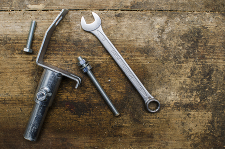 Tools and parts on old wooden tableの写真素材