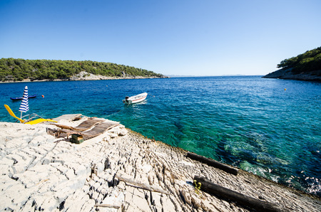 Chairs on a rocky beach in Croatiaの写真素材