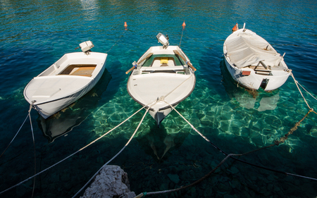 Boats in clear blue sea in summer timeの写真素材