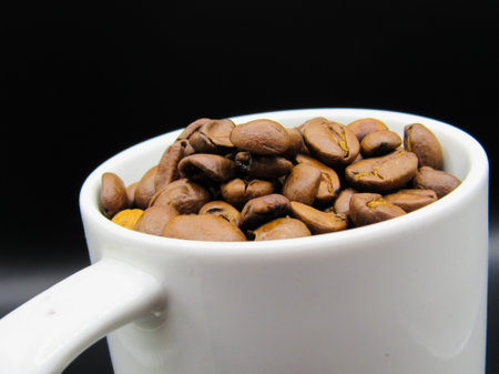 The top of a cup filled with coffee beansの写真素材