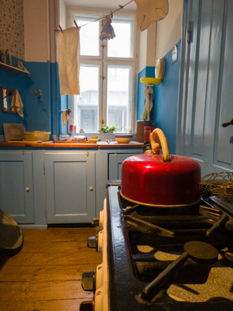Step back in time with this vintage kitchen from a 1960's Copenhagen apartment. A cozy gas stove and cluttered kitchen table make this a charming snapshot of a bygone era.の写真素材