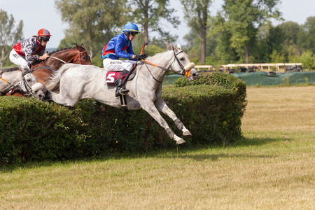 Lysa nad Labem, Czech Republic, July 6, 2018: Jockey and his horse jumps over the hedgeのeditorial素材