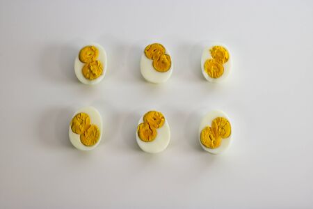 Three eggs cut to half each with two yolks