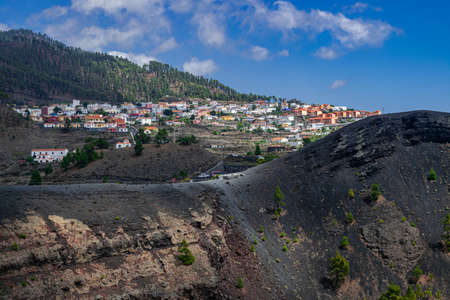 Fuencaliente, La Palma / Spain; September 11 2018: Fuencaliente volcanic landscape, with Los Canarios town background, people walking on volcanic park surface, La Palma, Canary islands, Spainのeditorial素材