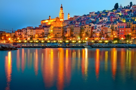 Menton Provence village at night with water reflectionの写真素材