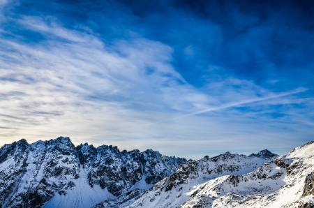 Winter mountains landscape with dark blue cloudy skyの写真素材