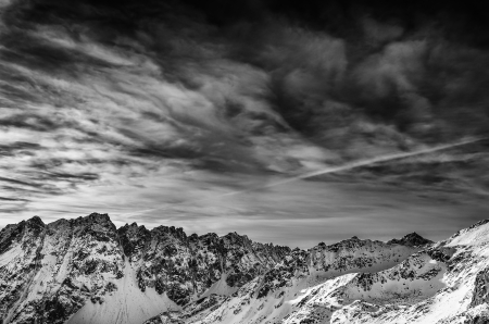 Winter mountains landscape with dark blue cloudy skyの写真素材