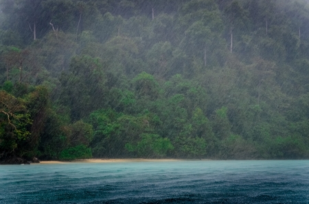 Ocean rain storm detail with green coast background and raindropsの写真素材