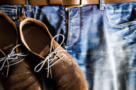 Detail of vintage style shoes on denim jeansの写真素材