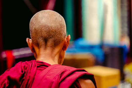 Detail portrait of buddhist monk in a robe from behindの写真素材