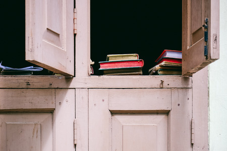 Detail of colorful books in vintage windowの写真素材
