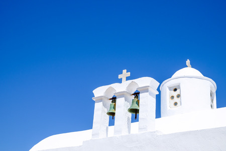 Detail view of bells and roof of traditional Greek cycladic church, Plaka village, Greeceの写真素材