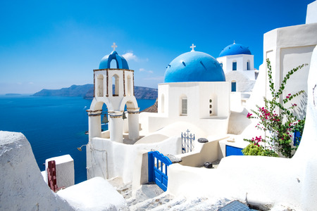 Scenic view of traditional cycladic white houses and blue domes in Oia village, Santorini island, Greeceの写真素材