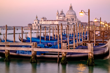 Cityscape view of Santa Maria Della Salute and gondolas at sunrise, Venice, Italyの写真素材