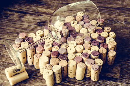 Detail of empty wine glass on corks in filtered old vintage styleの写真素材