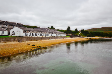 ISLAY, UNITED KINGDOM - 26 August 2013: Bunnahabhain distillery factory from the sea, Islay, United Kingdomのeditorial素材