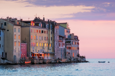 Old houses at ocean coast at colorful sunset in Rovinj, Croatia, Europeの写真素材