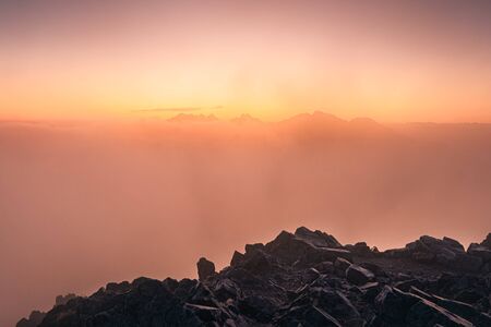 Colorful foggy sunrise over the mountains in High Tatras, Slovakia, Europe