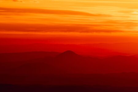 Tranquil landscape of layered mountains silhouettes during colorful sunrise, Slovakia, Europeの写真素材