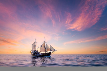 Seascape view with sailing boat and colorful cloudy sunset, Tenerifeの写真素材