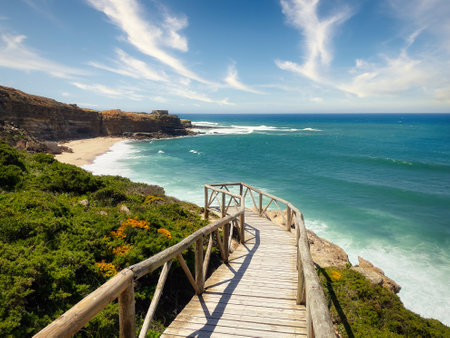 Beautiful landscape view of ocean coastline and wooden bridge, Ribeira dIlhas, Portugalの写真素材