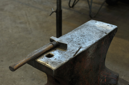 old anvil with hammer in a blacksmith's shopの写真素材