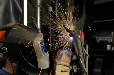 welder with protective cap at work