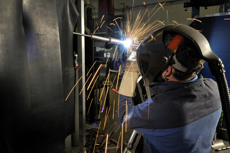 welder with protective cap at workの写真素材