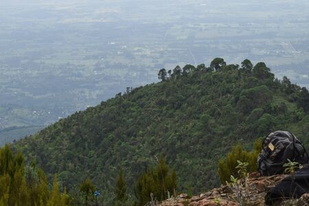 A backpack against a scenic mountain landscapes in rural Kenya, Aberdare Rangesの写真素材