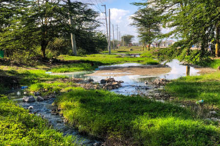 Dirty water flowing next to a highway in Nairobi, Kenya