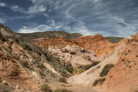 Strange cloud formations on colorful desert mountainsの写真素材