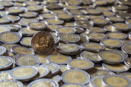 one peso coin on a group of focus coinsの写真素材