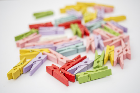 clothespins of different colors on white backgroundの写真素材