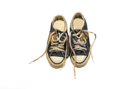 pair of worn blue jean shoes on white backgroundの写真素材
