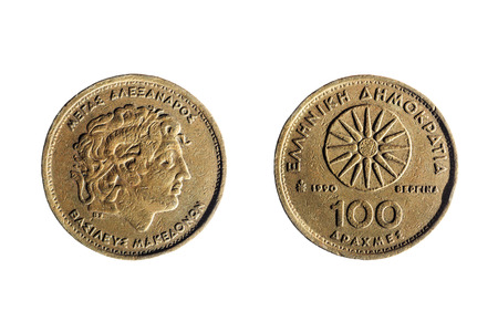 front and back of an old greek coin of a hundred drachmas isolated on white backgroundの写真素材