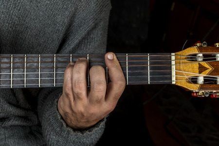 Left hand of man who is playing the guitarの写真素材