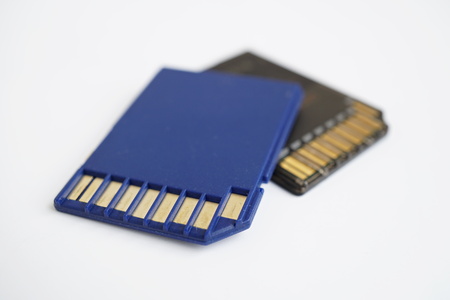 Two isolated plastic blue and black compact memory card (SD card - Secure Digital card) Used in cameras, computers and video cameras in a blue color with metal connectors in the golden colorの写真素材