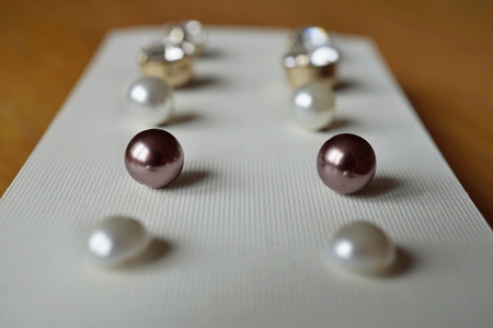 Set of earrings placed in the tray as a symbol of women's accessories, decoration and complementsの写真素材