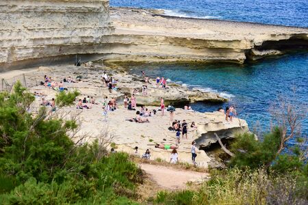 MARSAXLOKK, MALTA, may 06, 2019: People are enjoying sunny day at Saint Peter's pool near Marsaxlokk, Maltaのeditorial素材