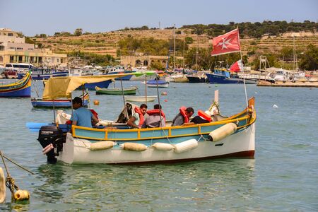 Traditional eyed colorful boats Luzzu in the Harbor of Mediterranean fishing village Marsaxlokk, Maltaのeditorial素材