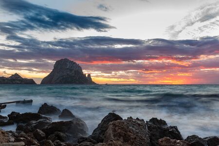 Small wooden pier in Cala d'Hort bay and view of Es Vedra island, Ibiza island, Spainの写真素材