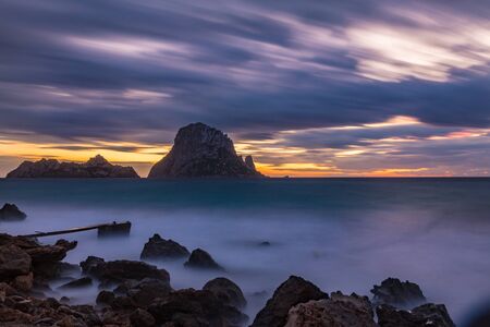 Small wooden pier in Cala d'Hort bay and view of Es Vedra island, Ibiza island, Spainの写真素材
