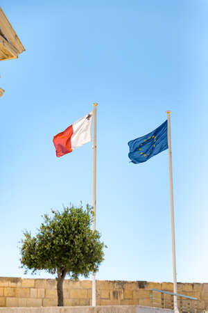 Flags of Malta and the European Economic Community in the City of La Valletta, Spain.