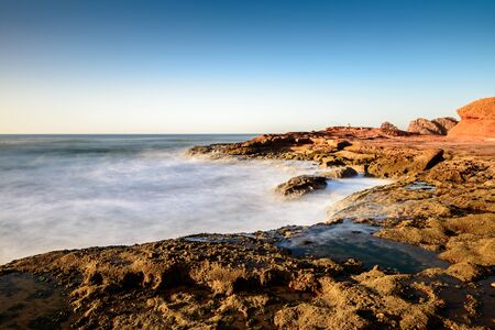 Landscape of Legzira Beach with its natural arches at the coast of Atlantic ocean. Legzira Beach is located on the ocean coast of Morocco, in Sidi Ifni, close to Agadir.の写真素材