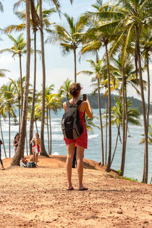 MIrissa, Sri Lanka : 2019 20 Nov : People on a cloudy sunrise on the coconut palm hill in the western province of Mirissa, Sri Lankaのeditorial素材