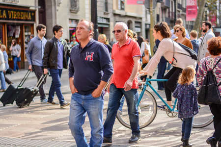 Barcelona, Spain : 2016 NOV 1 : Sunny day with People on the Rambla in Barcelona,...