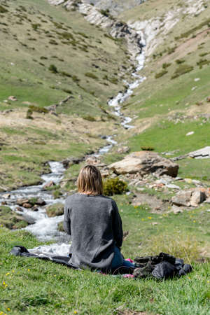 Young Woman whit mask in Montaup river in Canillo, Andorra in spring.のeditorial素材