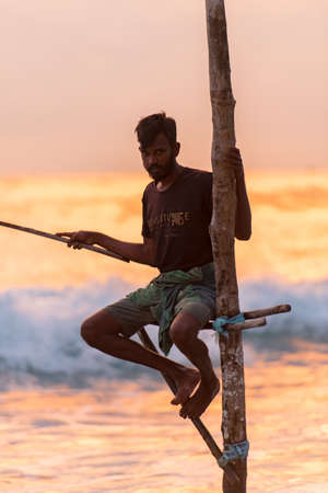 Koggala, Sri Lanka : 2019 Nov 18 : Silhouettes of the traditional Sri Lankan stilt fishermen on a stormy in Koggala, Sri Lanka. Stilt fishing is a method of fishing unique to the island country of Sri Lankaのeditorial素材