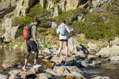 Grau Roig, Andorra : May 20 2020 : Two young hikers are Lake in the circuit of Lake Pessons Grau Roig, Andorra in spring.のeditorial素材